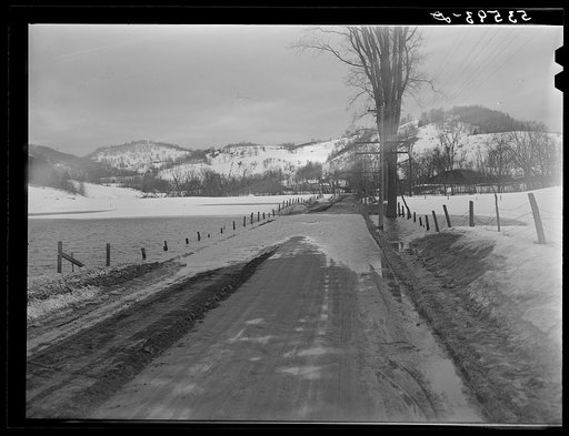 Spring thaw flooding field and road near Woodstock, Vermont