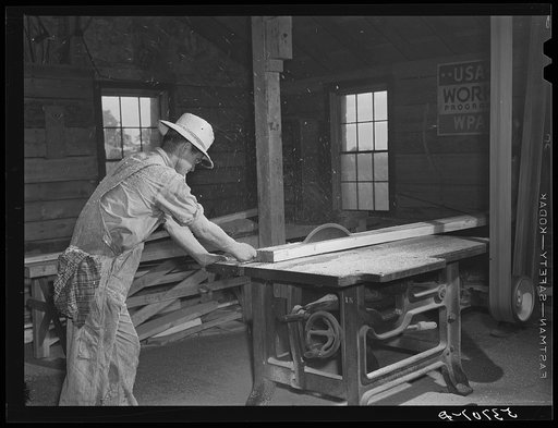Sawing board in woodworking shop. Community service center, Centerville, Arkansas. Faulkner County (see general caption)