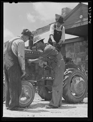 Farmers repairing tractor at community service center. Faulkner County, Centerville, Arkansas (see general caption)