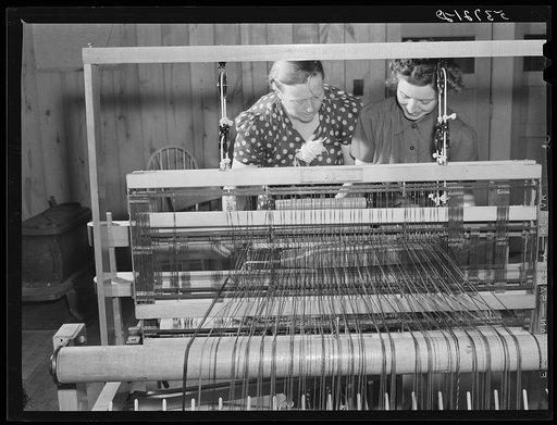 Mrs. Aline Koger, home management supervisor, helping Mrs. Lloyd Young, FSA (Farm Security Administration) borrower's wife with her weaving. Plum Bayou Project, Arkansas (see general caption)
