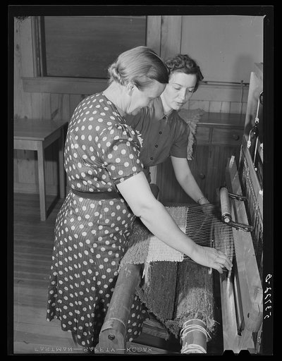 Mrs. Aline Koger, home management supervisor, helping Mrs. Lloyd Young, FSA (Farm Security Administration) borrower's wife with her weaving. Plum Bayou Project, Arkansas (see general caption)