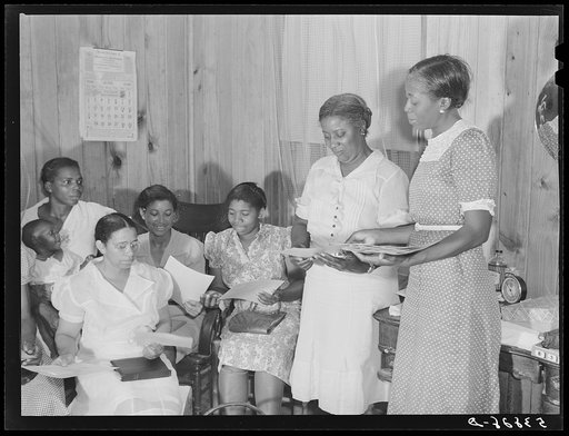 Minnie Lewis, president of home demonstration club, with home economist Rachel D. Moore, showing and explaining weaving samples which they might be able to make on the project. La Delta, Thomastown, Louisiana