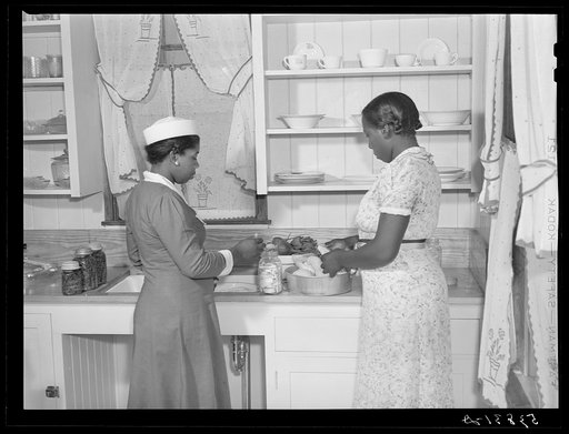Violet Davenport and Almary Kelly canning squash during a canning demonstration given by home economist Rachel D. Moore at La Delta Project. Thomastown, Louisiana