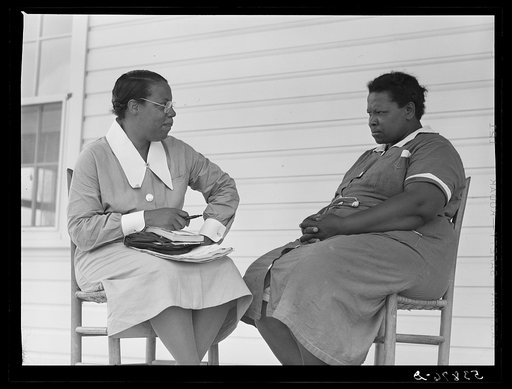 Nurse Marguerite White making plans for next meeting with Rosie Patterson, assistant secretary of Busy Bee homeworkers club on La Delta Project. Thomastown, Louisiana
