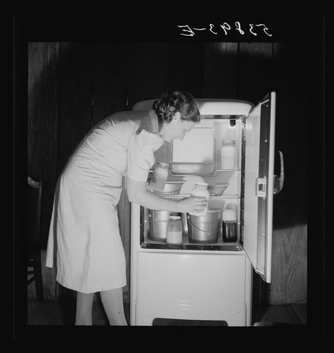 Mrs. Pleas Rodden putting fresh milk from their own cow in their frigidaire. They are FSA (Farm Security Administration) rural rehabilitation borrowers. West Carroll Parish, Louisiana