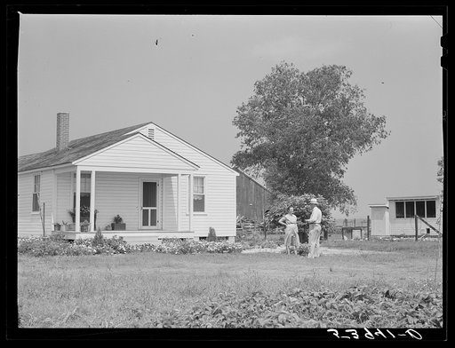Project manager Mr. B.A. Brady talking to Mrs. J.G. Stanley, one of project families, in front of her home. Transylvania Project, Lousiana