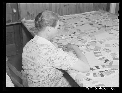 Untitled photo, possibly related to: Mrs. Clarence N. Pace with her children and her mother-in-law quilting in their home. Transylvania Project, Louisiana