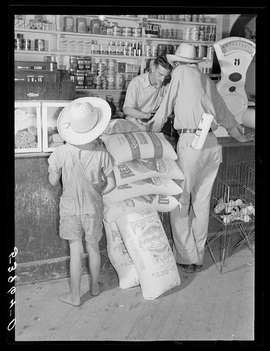 One of project family buying groceries and supplies in their co-op store. Transylvania Project, Louisiana
