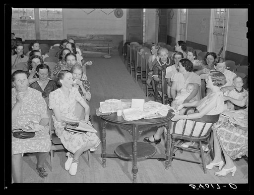 Untitled photo, possibly related to: The women's club leaving the church and community building after a home management demonstration by the supervisor and a baby shower they gave for Mrs. Verden Lee, one of their members. Transylvania Project, Louisiana