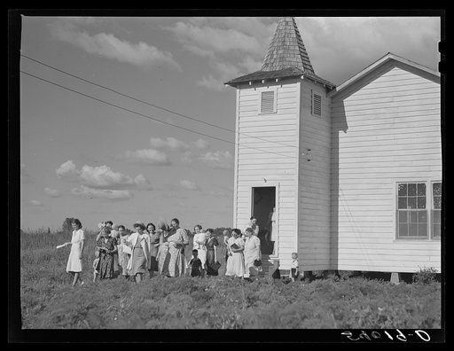 The women's club leaving the church and community building after a home management demonstration by the supervisor and a baby shower they gave for Mrs. Verden Lee, one of their members. Transylvania Project, Louisiana