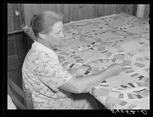 Mrs. Clarence N. Pace's mother-in-law quilting in their home. Transylvania Project, Louisiana