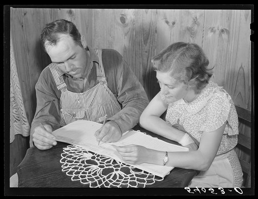 Mr. and Mrs. Verden Lee working on their farm and home family record book. Transylvania Project, Louisiana
