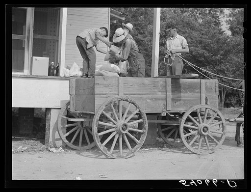 One of the project families loading up their wagon with supplies at the cooperative store. Transylvania Project, Louisiana