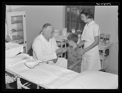 Untitled photo, possibly related to: Dr. William J. Buck gives typhoid shot to one of camp members with Marjory Fowler, NYA (National Youth Administration) member assisting the nurse. Osceola migratory labor camp, Belle Glade, Florida