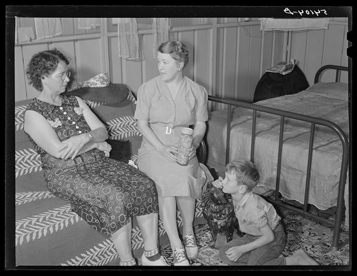 Home management supervisor Mrs. Merrin discusses the canning program with one of camp members inside her shelter. Osceola migratory labor camp. Belle Glade, Florida
