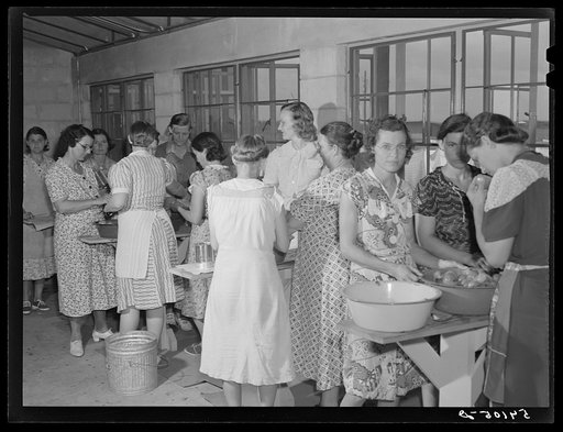 Camp members canning tomatoes in the utility building at Osceola migratory labor camp. Belle Glade, Florida