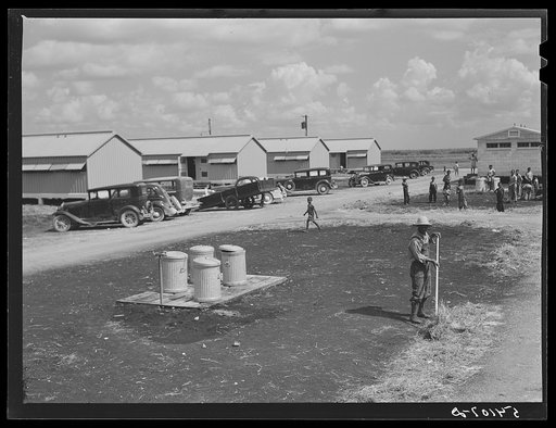 Running water and garbage and refuse disposal cans are placed at head of each shelter unit division at Okeechobee migratory labor camp. Belle Glade, Florida
