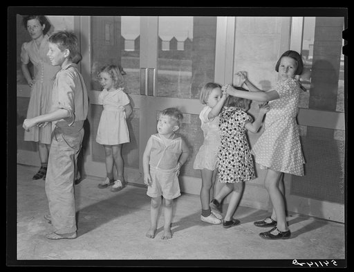 Supervised play hour for younger children in assembly building at Osceola migratory labor camp. Belle Glade, Florida