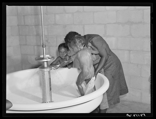 Untitled photo, possibly related to: Showers for both babies and older children and for parents and complete laundry facilities are provided in the utility building for members of the Okeechobee migratory labor camp. Belle Glade, Florida