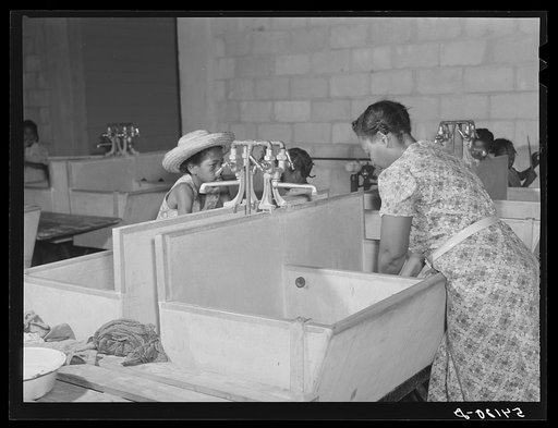 Untitled photo, possibly related to: Showers for both babies and older children and for parents and complete laundry facilities are provided in the utility building for members of the Okeechobee migratory labor camp. Belle Glade, Florida