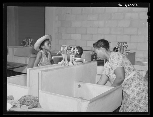 Showers for both babies and older children and for parents and complete laundry facilities are provided in the utility building for members of the Okeechobee migratory labor camp. Belle Glade, Florida