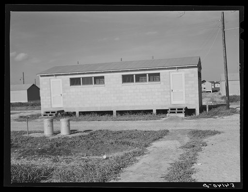 Untitled photo, possibly related to: Large comfort stations, toilets and washroom are at each end of the shelter units. Osceola migratory labor camp, Belle Glade, Florida
