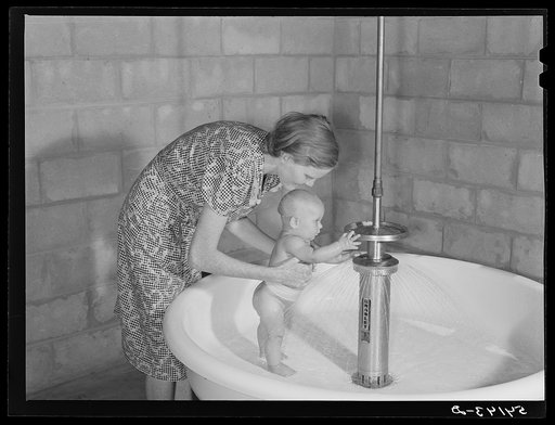 Showers for both babies and older children and parents and complete laundry facilities are provided in the utility building for members of the Osceola migratory labor camp. Belle Glade, Florida