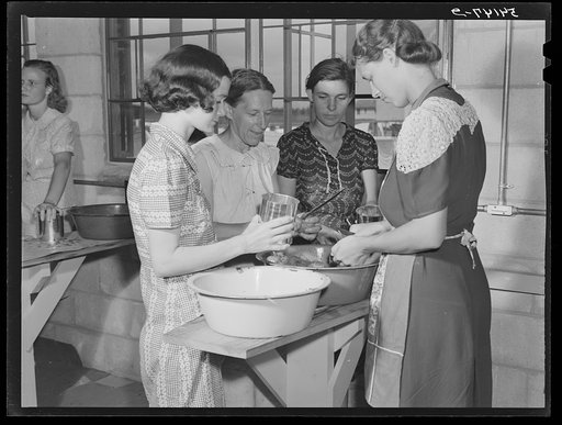Camp members canning tomatoes in the utility building at Osceola migratory labor camp. Belle Glade, Florida