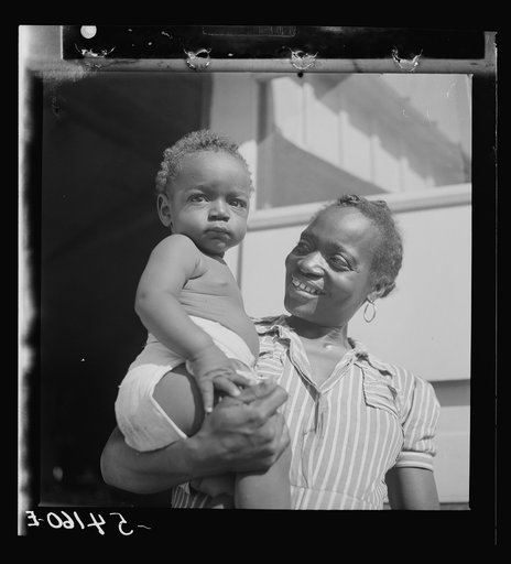 Mother and child at Okeechobee migratory labor camp, where they have a nurse and clinic for prenatal and postnatal care. Belle Glade, Florida