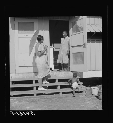 Home management supervisor Corinne Williams visits one of the families in Okeechobee migratory labor camp. Belle Glade, Florida