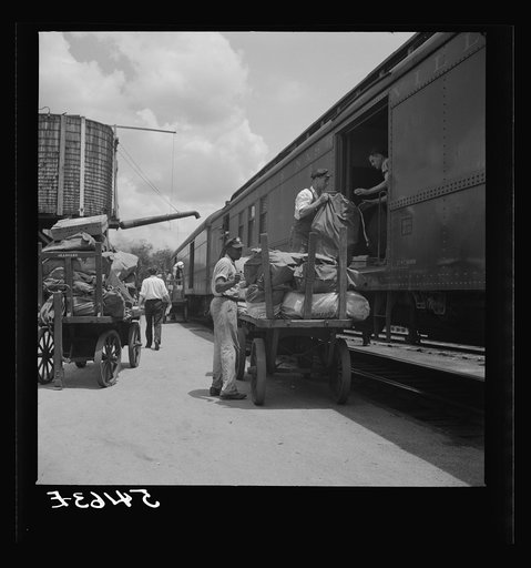 Loading mail into mail car. L&N railroad station, North Florida