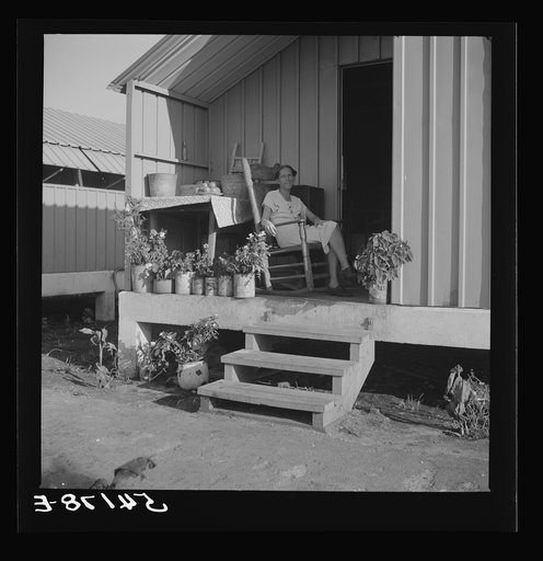 Camp member on porch of her shelter at Osceola migratory labor camp. Belle Glade, Florida