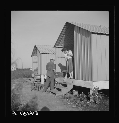 Camp member on porch of her shelter at Osceola migratory labor camp. Belle Glade, Florida