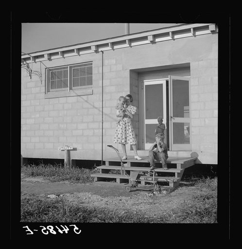 Children coming into utility building after their showers. It is also equipped with complete laundry facilities. Osceola migratory labor camp,  Belle Glade, Florida