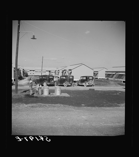 Untitled photo, possibly related to: Running water and garbage and refuse disposal cans are placed at head of each shelter unit division at Okeechobee migratory labor camp. Belle Glade, Florida