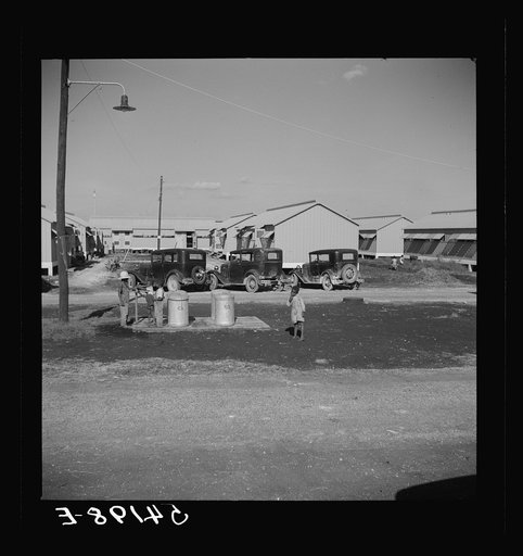 Untitled photo, possibly related to: Running water and garbage and refuse disposal cans are placed at head of each shelter unit division at Okeechobee migratory labor camp. Belle Glade, Florida