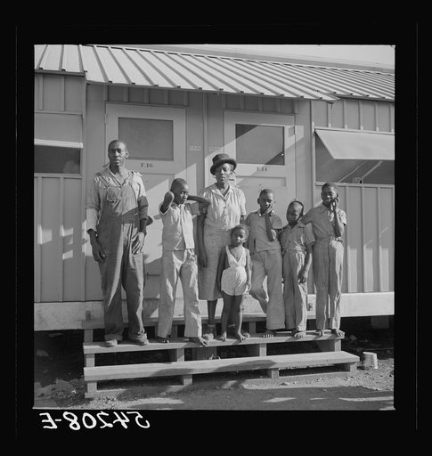 The Robinson family outside their shelter at Okeechobee migratory labor camp. Belle Glade, Florida