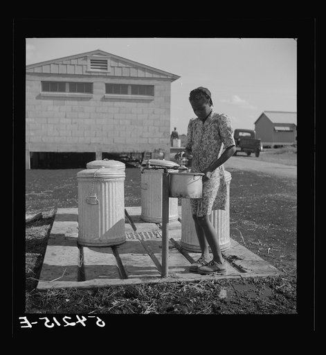 Untitled photo, possibly related to: Running water and garbage and refuse disposal are placed at head of each shelter unit division of Okeechobee migratory labor camp. Belle Glade, Florida