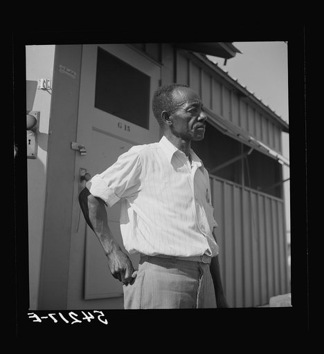 Camp member moving into shelter at Okeechobee migratory labor camp. Belle Glade, Florida