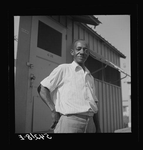Camp member moving into shelter at Okeechobee migratory labor camp. Belle Glade, Florida