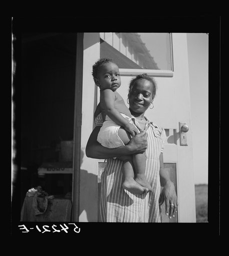 Mother and child at Okeechobee migratory labor camp where they have a nurse and clinic for both prenatal and postnatal care. Belle Glade, Florida