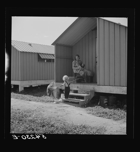 Camp members' children are taking an interest in keeping shelters and grounds clean. Osceola migratory labor camp. Belle Glade, Florida