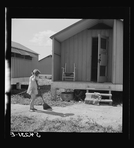 Camp members' children are taking an interest in keeping shelters and grounds clean. Osceola migratory labor camp. Belle Glade, Florida