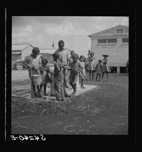 Untitled photo, possibly related to: Running water and garbage and refuse disposal are placed at head of each shelter unit division of Okeechobee migratory labor camp. Belle Glade, Florida