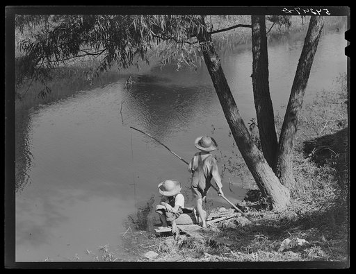 Cajun children fishing in a bayou near the school by Terrebonne Project. Schriever, Louisiana