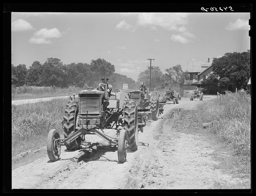 Tractors going to cultivate the sugarcane fields at one o'clock. Terrebonne Project, Schriever, Louisiana
