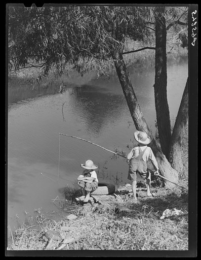 Cajun children fishing in bayou near the school by Terrebonne Project. Schriever, Louisiana