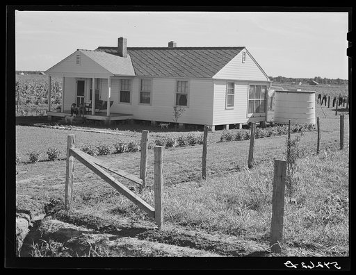 Home with covered cistern for water and fenced garden on Terrebonne Project. Schriever, Louisiana