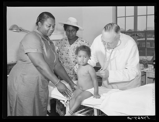 Doctor William J. Buck examining child, with mother and camp nurse assisting, in clinic at Okeechobee migratory labor camp. Belle Glade, Florida