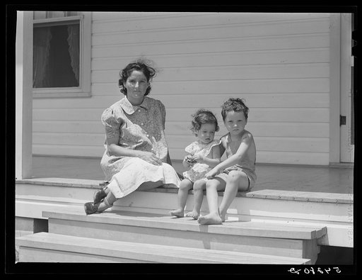 Wife and children of one of the cooperative's members on steps of their home. Terrebonne Project, Schriever, Louisiana